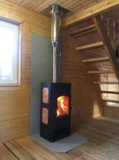 Популярный камин с дровницей Сибирь 8 в интерьере фото в Гомеле